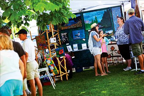 Like the 2015 festival pictured left, art created using a variety of mediums will be displayed and sold at the Sandpiper’s annual art festival on the courthouse lawn this Saturday.