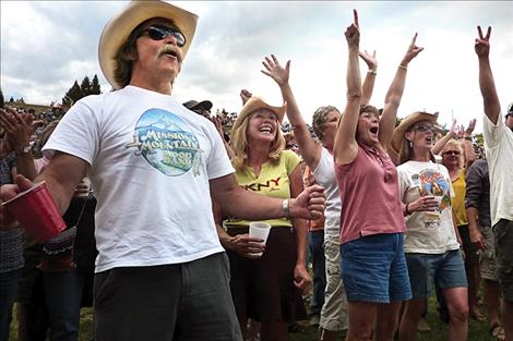 Enthusiastic fans sport the band’s gear and cheer them on.