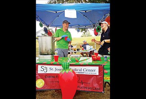 Landon Godfrey and Shelley Quinn share a laugh Saturday at the Rotarians’ Chili Cookoff at Riverside Park. They were part of a team from St. Joseph’s Hospital, one of 13 that competed. 