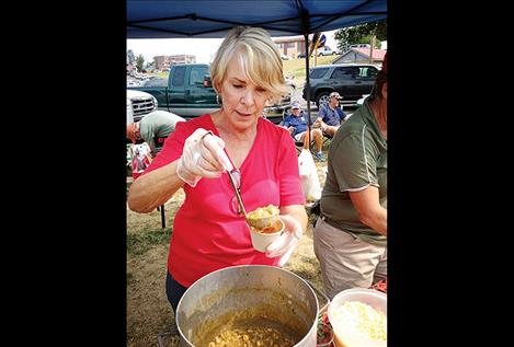 Jeanette Phillips serves some chili verde with pork and white beans for the Red Hot Chili Mamas, who won the People’s Choice award and placed third overall. 