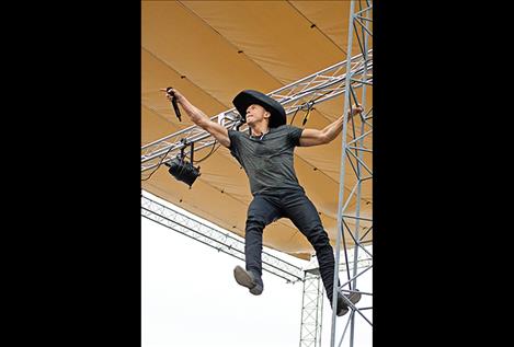  Sam Riddle hangs from the pillar 15 feet off the stage during one of his songs.
