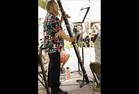 Michael Kramarczyk of the Flathead Flute Choir playing the Contra-Bass Flute at the Art Festival. The Flute Choir was one of several musicians who played Saturday.