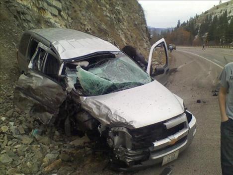 A St. Ignatius School van rests against the mountainside after being sideswiped by a pickup truck traveling in the opposite direction. 