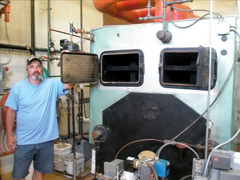 John Hipp stands next to a 1955 boiler that’s been at Cherry Valley Elementary since 1963. Hipp said that prior to being installed at the school, the boiler was used on an ocean ship.