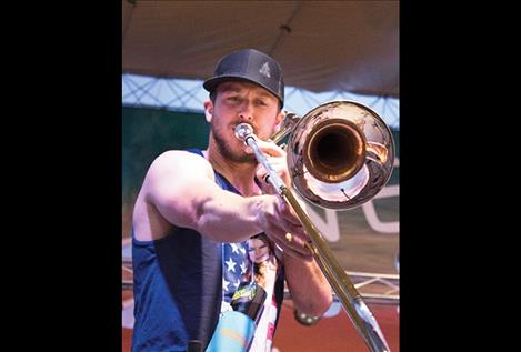 Kyle Daugherty of the Off In the Woods band plays the trombone.