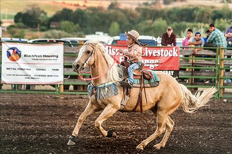  Brinley Tatsey sets the pace for the Tiny Tots barrel racing.