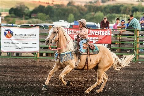 Brinley Tatsey sets the pace for the Tiny Tots barrel racing.