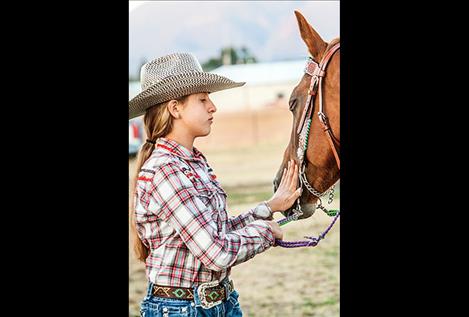 Taylissa Lytle has a quiet moment with her horse before competing. 