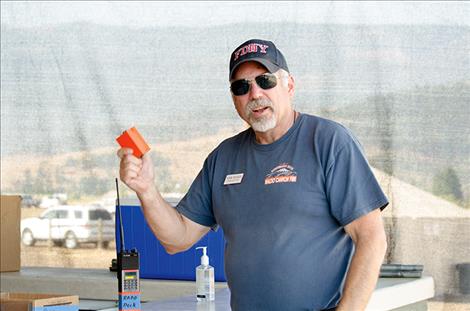 Information Officer Norm Rooker puts batteries into one of the radios firefighters use. 