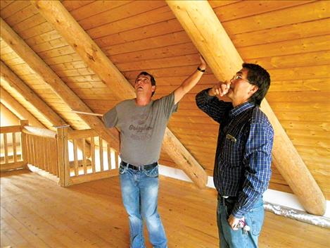 Jay Brewer and CSKT Maintenance Department Manager John Neiss look at progress in the upstairs of the main house at the Kuki A’kilwiy sober living house north of Hot Springs. 
