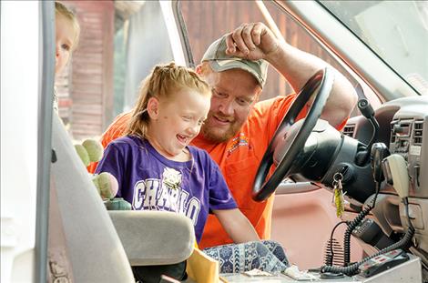 Volunteer firefighter Matt Hout shows his daughter, Peyton, 6, the inside of the ambulance.
