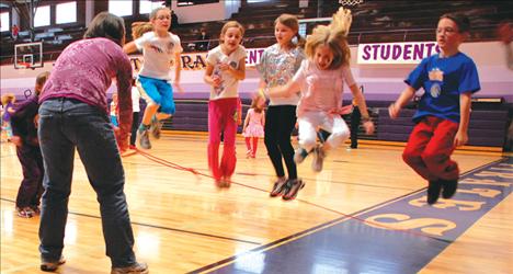 Getting some air, Ali Hupka, left, Hailey Helm, Madeleine Bissegger, Aubree Roberts and Owen McElwee jump as Deanna McElwee twirls the circle rope.