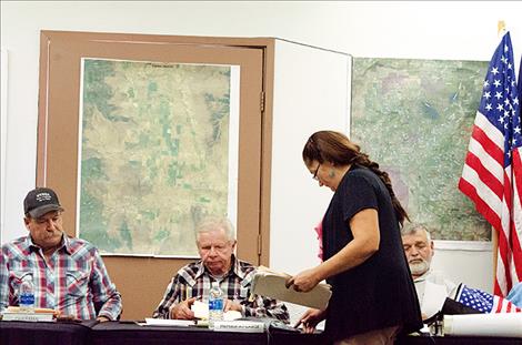Chantelle Begay, the new secretary for the Flathead Joint Board of Control, distributes information during the Sept. 12 meeting.