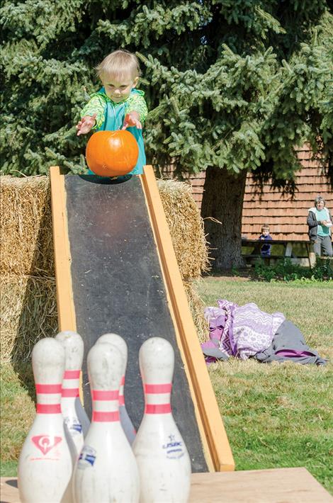 Jessica Bruekmann tries out her pumpkin bowling skills. 