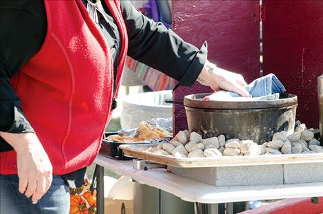 A Dutch oven sits on hot coals ready for a batch of fry bread.