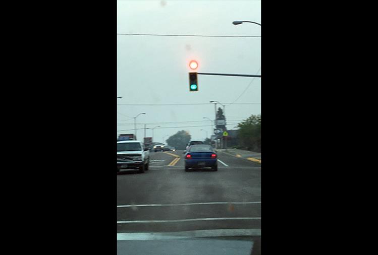 Taken at the stoplight at U.S. Hwy. 93 and First Street East in Polson, smoke makes the sun look like a red light.