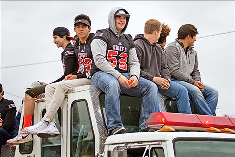 The Chiefs football team rides on a Ronan Volunteer Fire Department truck.