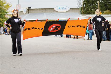 Chiefs and Maidens banner is carried down Main Street during a parade to celebrate homecoming. 