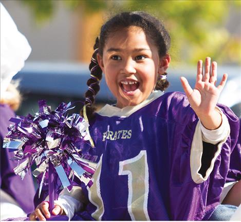 ittle Lady Pirate Kahalia Thomas waves to the crowd.