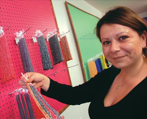 Dacia Whitworth, proprietor of Northern Creations, displays some of her tri-cut beads. The way the beads are cut makes them sparkle.