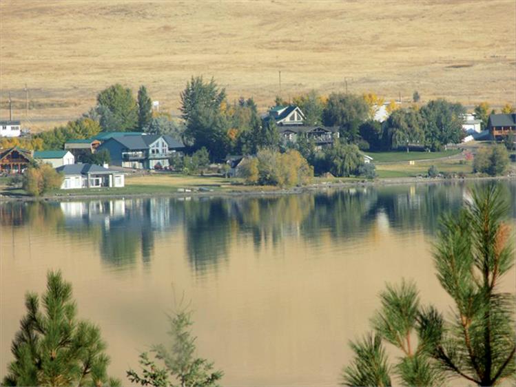 A golden light washes over homes, fields and the lake at Elmo Bay on Sept. 29.