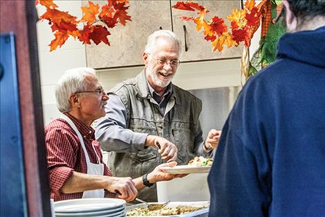 Marvin Walchuk and Jeff Tschida serve Shepherd’s Pie last Friday night at the Immaculate Conception Church in Polson.