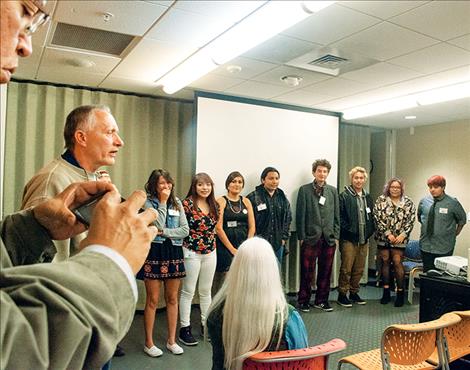 Teacher David  Spear introduces Rez  Made photographers to  an audience of people  at the museum. 