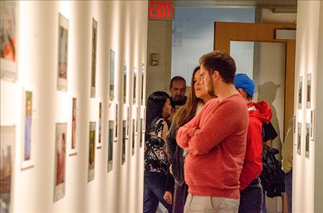 People view the photos of 14 Two Eagle  River School students.  