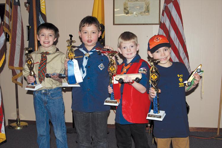Tiger Cub Scouts Tommy Sherry, right, first place; Cooper Clark, second place; Blaise Burland, third place; and Austin Burland, fourth place; show off their trophies and racecars after the annual Pinewood Derby in Polson. The top three finishers, Sherry, Clark and Burland, will compete in the district derby March 23 in Plains. Pack 4947 would like to thank the Elks Lodge in Polson and Ben Anciaux for being such gracious hosts for the Pinewood Derby.