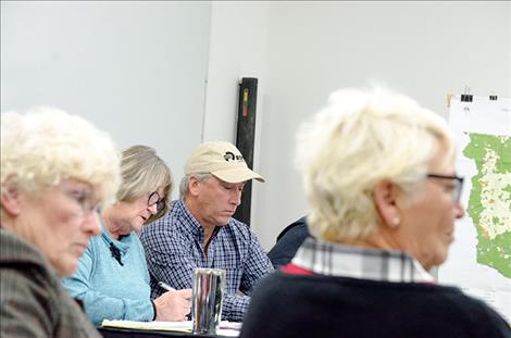 Flathead Joint Board of Control members look at agenda minutes during the regular meeting on Tuesday.