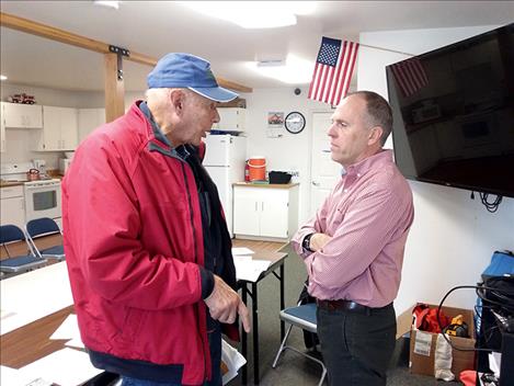 Polson resident Chuck Jarecki talks with State Rep. Greg Hertz on Friday after the Pachyderm Club meeting. 