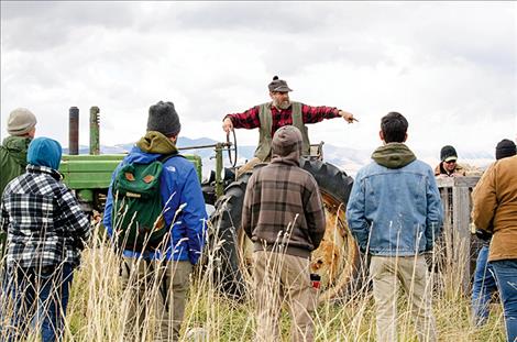 Dave Sturman talks to veterans, current military members, and their families about hooking a pigpen to a tractor and moving it to different locations on his farm.