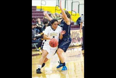 Lady Bison Kaylea Skunkcap drives to the hoop.