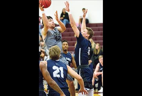 Zachary Mills shoots above defenders.