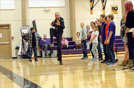 Mike Beers and Tyler Nielsen ask the students to help  perform a live slide show to reenact a few traveling adventures.