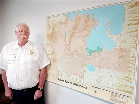 Gordon Gieser, the new Polson Rural Fire Chief, stands beside a map that shows the 200-square-mile area of the rural fire district.