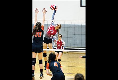 Scarlet Ashely Revis skies above the net during district play Oct. 26.