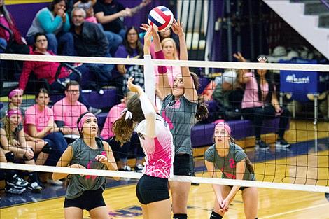 Scarlet Tomi Brazill taps it over the net during district play Oct. 27