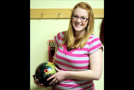 Megan Jennison holds the ball she used during her perfect game.