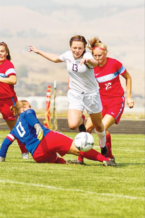 Lady Pirate Ashlee Howell hurdles defender on her way to a score.