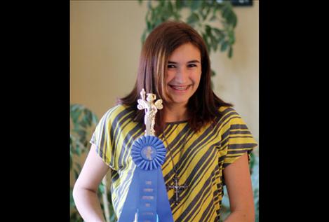 Suzanah Clark holds her first-place trophy from the Lake County Spelling Bee.