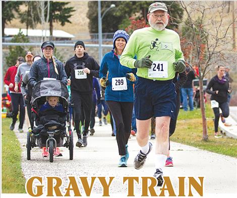 Turkey Trot runners clip down the bike path along Montana State Highway 35 early Thanksgiving morning. 