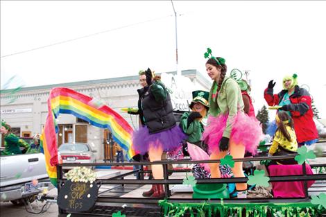 Erin Bennet, Cassie Corum and Larinda Fimbres toss candy to parade-goers Sunday from a float for Fimbres’ nail salon, Show Off Your Tips. 