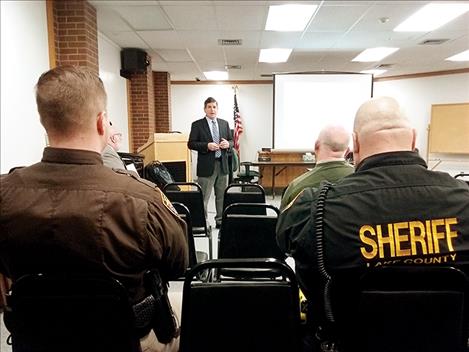 Undersheriff Ben Woods, left, listens to consultant Mark Goldman.