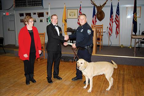 Elks Lodge 1695 Drug Awareness Chairperson Beverly Barrett and Exalted Ruler Chad Komlofske present Polson Police Detective Allan Booth and K-9 Officer Brody a check for $2,752 to be used for the purchase of a new drug dog upon Brody’s retirement.
