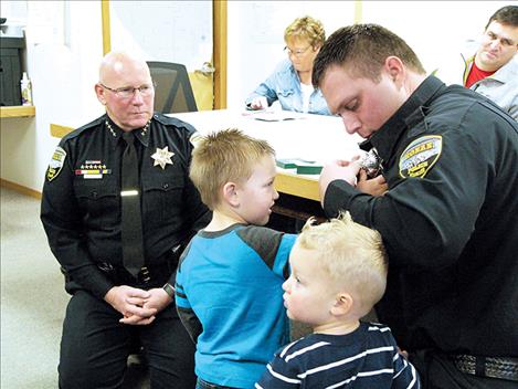 Far left, Jonathan Gilliland is sworn in as a Ronan Police reserve officer last week by Police Chief Ken Weaver. 