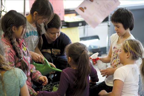 While everyone else was heading back to the classroom, these students hung back to give their plants a little extra water.