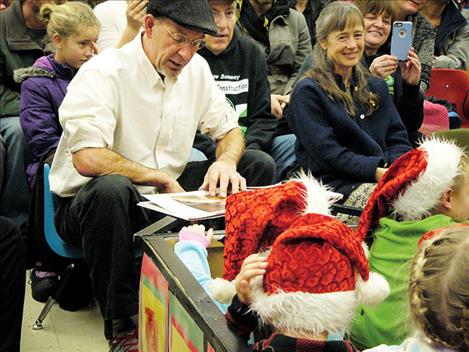 Kindergarten teacher Frank Sucha reads during the 26th annual reading/acting of Polar Express by his class. 