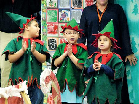  Three elves sing, from left, Bennett Evans, Ruby Barnaby and Jazmin McElderry. 