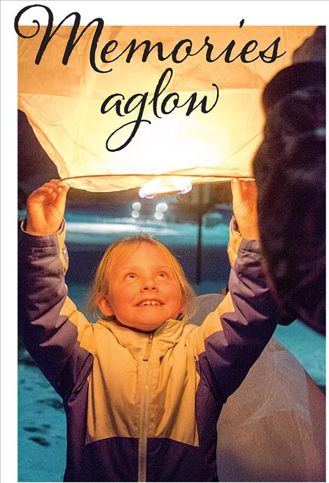 Finlay Taylor, 7, holds onto a lantern as the hot air from the flame causes it to rise. 
